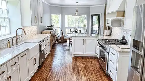 Modern kitchen remodel with custom white cabinetry and quartz countertops in Tulsa by Story Remodeling