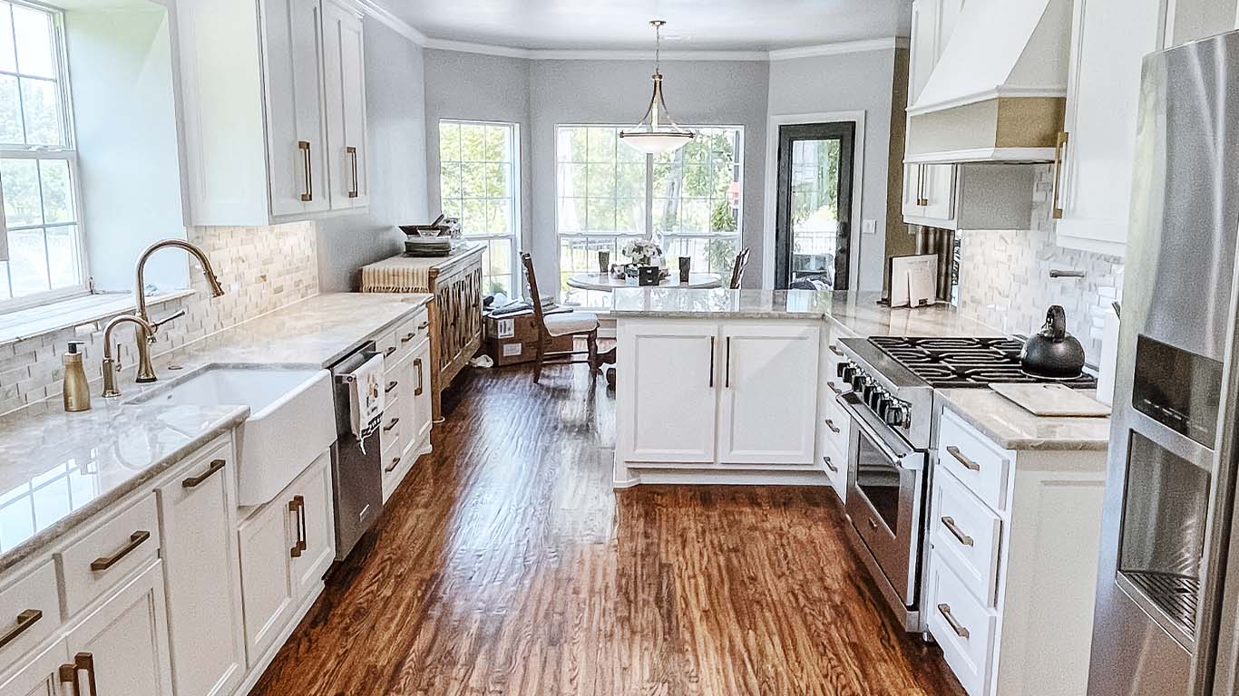 kitchen Modern kitchen remodel with custom white cabinetry and quartz countertops in Tulsa by Story Remodeling