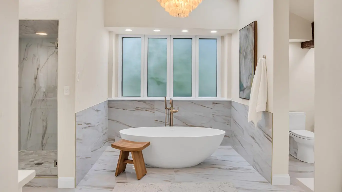 Modern bathroom remodel in Broken Arrow OK with double vanity, quartz countertops, and updated lighting
